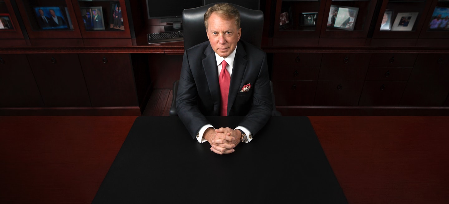 Photo of CME Group Chairman and Chief Executive Officer Terrence A. Duffy, sitting at a desk, with his hands folded.